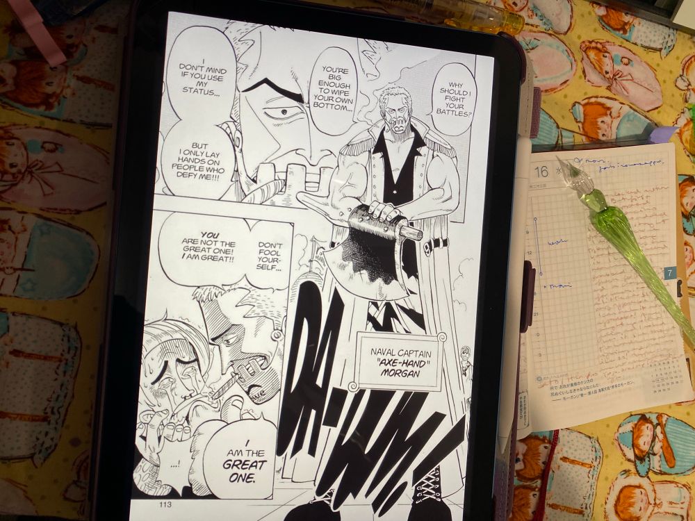 One Piece hobonichi open to the July 16 page underneath an iPad displaying manga 