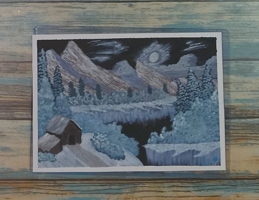 Winter landscape with mountains and trees on a lake with snow at night time.