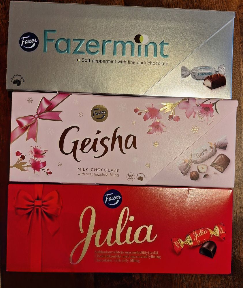 Three boxes of chocolates, silver, red and pink. Fazer's Fazermint
Soft peppermint with fine dark chocolate filling.
Fazer's Geisha
Milk chocolate with soft hazelnut-filling.
Fazer's Julia 
Chocolates with jelly filling.
