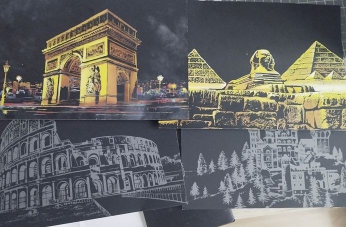 4 postales con ilustraciones para rascar. Fondo negro con las siluetas del Arco de Triunfo, Pirámides, Coliseo y Castillo en bosque. Se rasca la silueta y debajo se ven los colores, brillantes, de la ilustración.