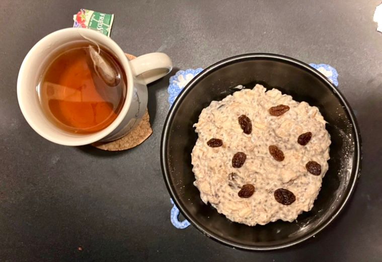 A cup of berry tea.
A bowl of oat meal made with a five grain mix, milk, cinnamon, raisins, chia seeds, protein powder and a dash of salt.