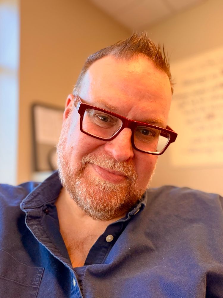 A selfie of me smiling with navy shirt on