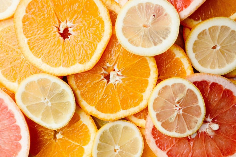 Close-up of fresh, sliced citrus fruits showcasing oranges, lemons, and grapefruits.