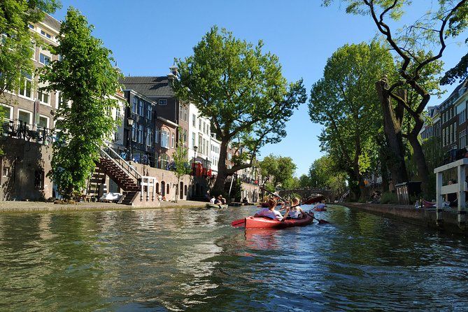 People sailing through the historic canals in Utrecht Credit: https://www.viator.com/nl-NL/tours/Utrecht/Utrecht-Kayak-Tour/d24976-145673P2