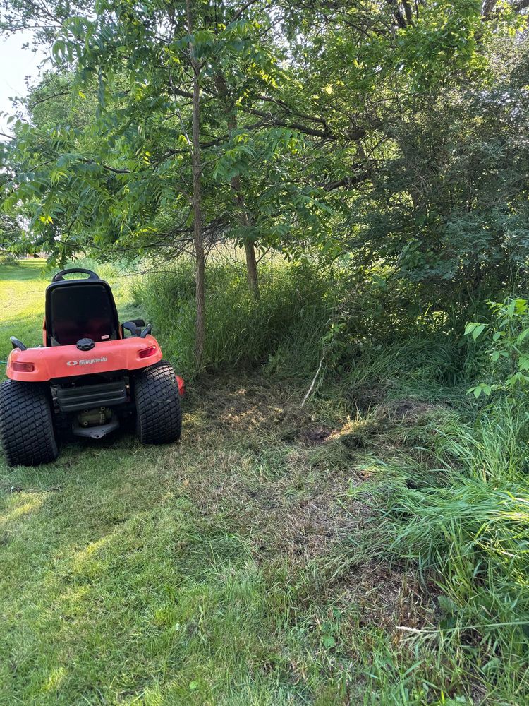 Riding lawn mower I had gotten stuck trying to cut back brush. I pulled it out with my truck and a heavy chain I found in the barn. 
