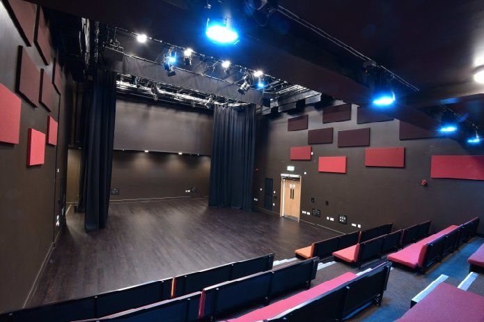 Stage Two. A black box studio theatre with tiered bench seating.