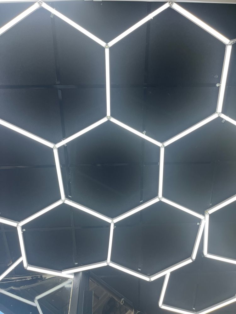 Fluorescent light tubes arranged in a hexagonal tiling pattern