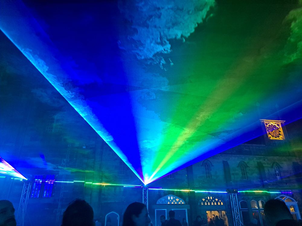 A blue and green laser projected just above head height in Lancaster Castle