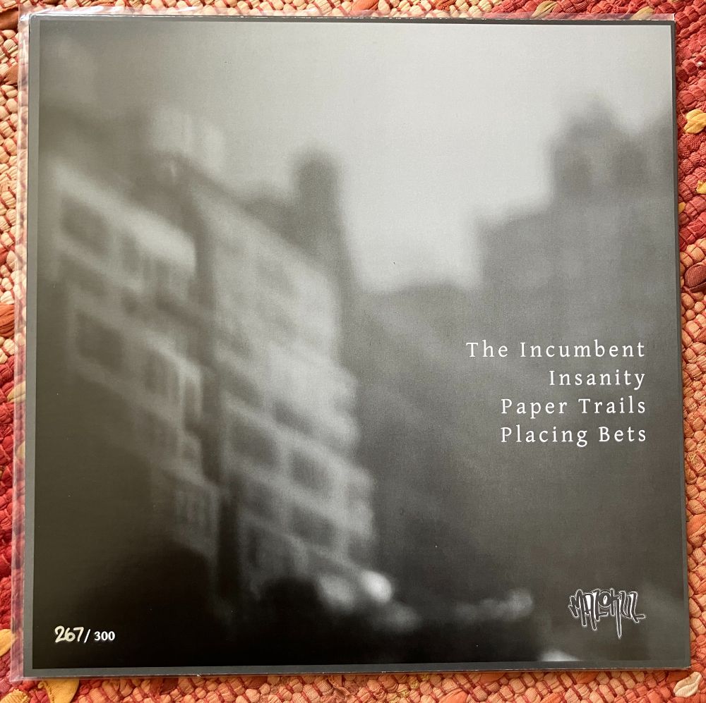 Back cover of the "Architectural Failures" 12" by Drugs of Faith. It's got the song titles listed.