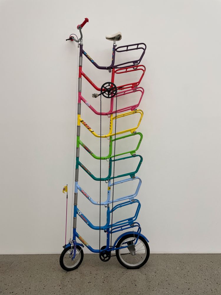 Piece of art in the form of stacked bicycle frames in rainbow colours