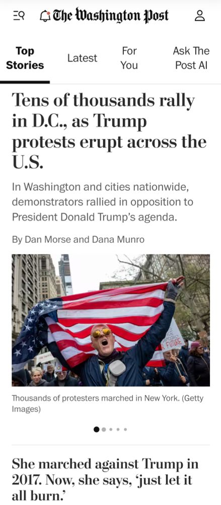 Washingtonpost.com homepage showing the headline "Tens of thousands rally in DC as Trump protests erupt across the US," followed by "In Washington and cities nationwide, demonstrators rallied in opposition to President Donald Trump's agenda." Below that is a photo of a man holding an American flag with many other demonstrators around him. Below that is the headline of a separate article, "She marched against Trump in 2017. Now, she says, 'just let it all burn.'"