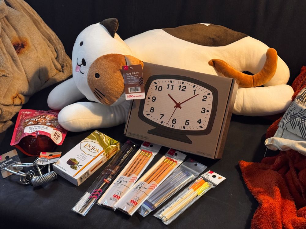 my Daiso haul - a kitty plush, clock, pens/pencils, snacks