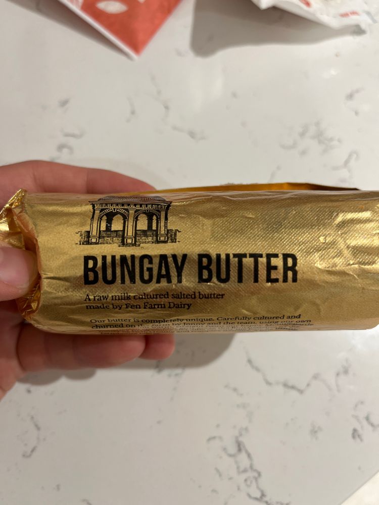 A photo of a Bungay Butter, in a gold foil wrapper. 