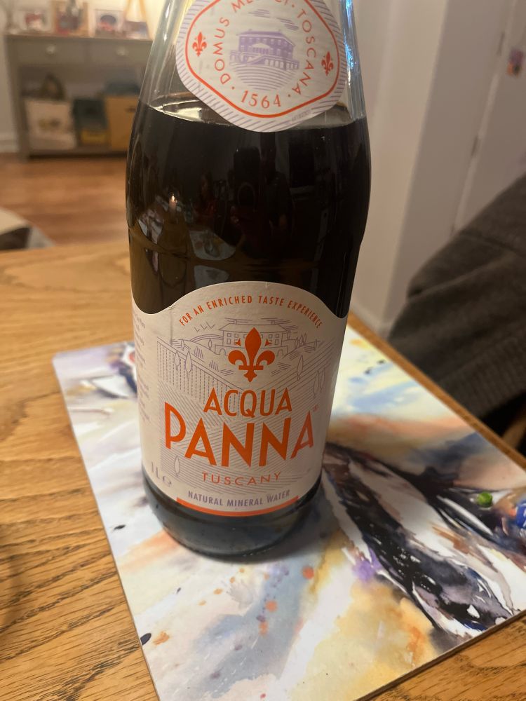 Home made red wine in a glass bottle which was originally for spring water 