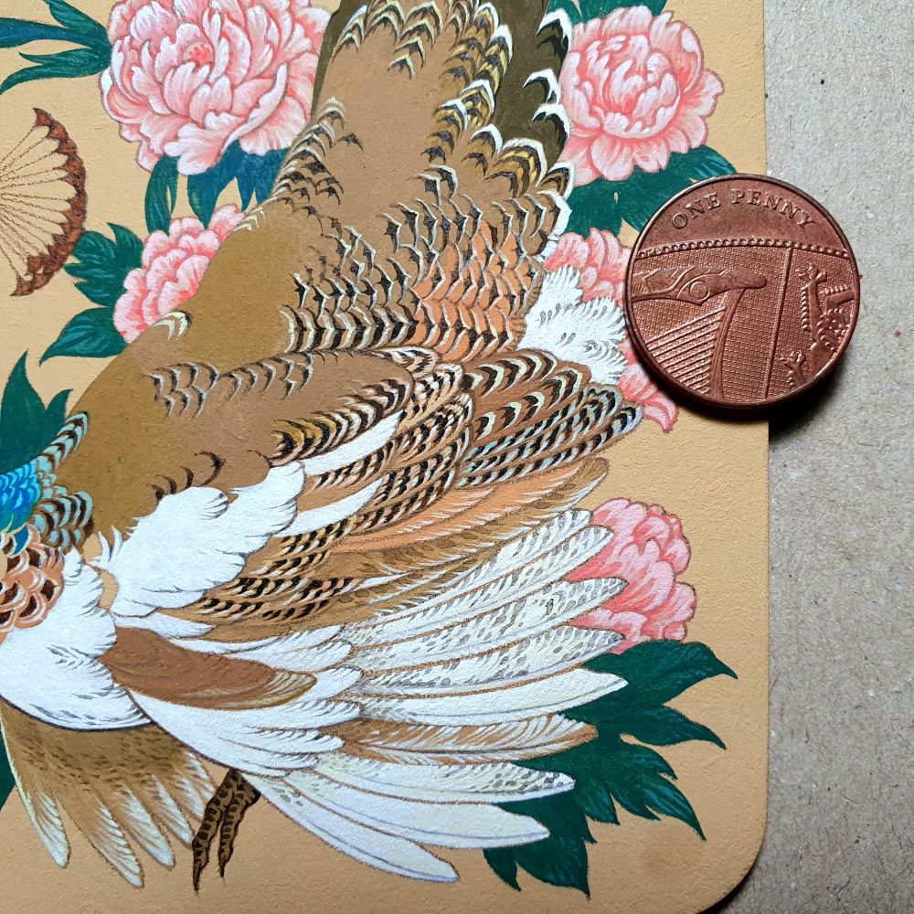 Detail of wing and tail feathers from a work in progress. The feathers are mainly various hues of brown and white with barred markings. The piece is very small and intricate. 