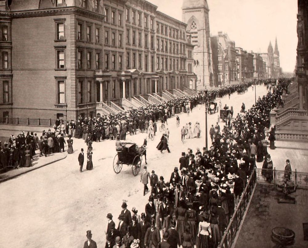 Crowded sidewalks on 5th Avenue, with people dressed in their Sunday best. Many are coming from Easter services. This view is looking north from 47th Street. 