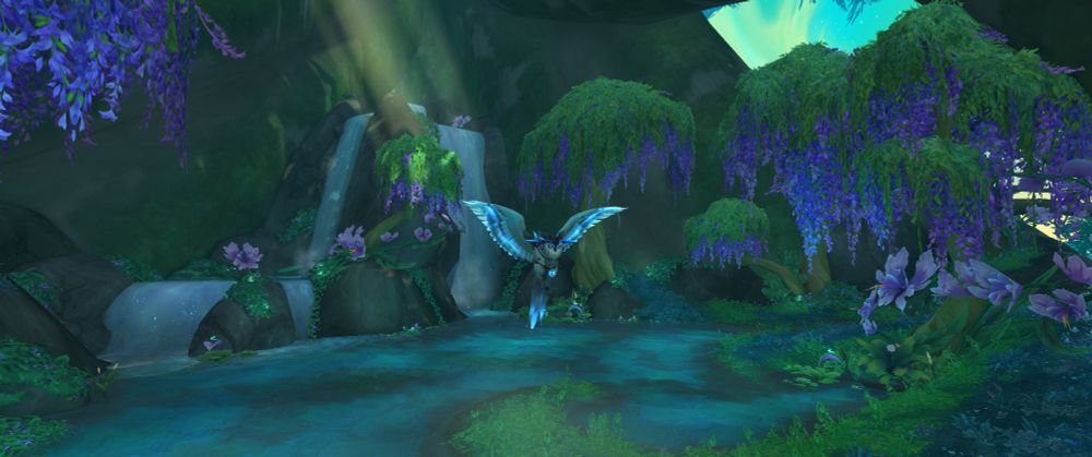Screenshot from the Emerald Dream in Wow. My character riding a beautiful owl over a lake with a waterfall in the background and purple wysteria like trees. Sunlight streams down from the canopy of trees. 