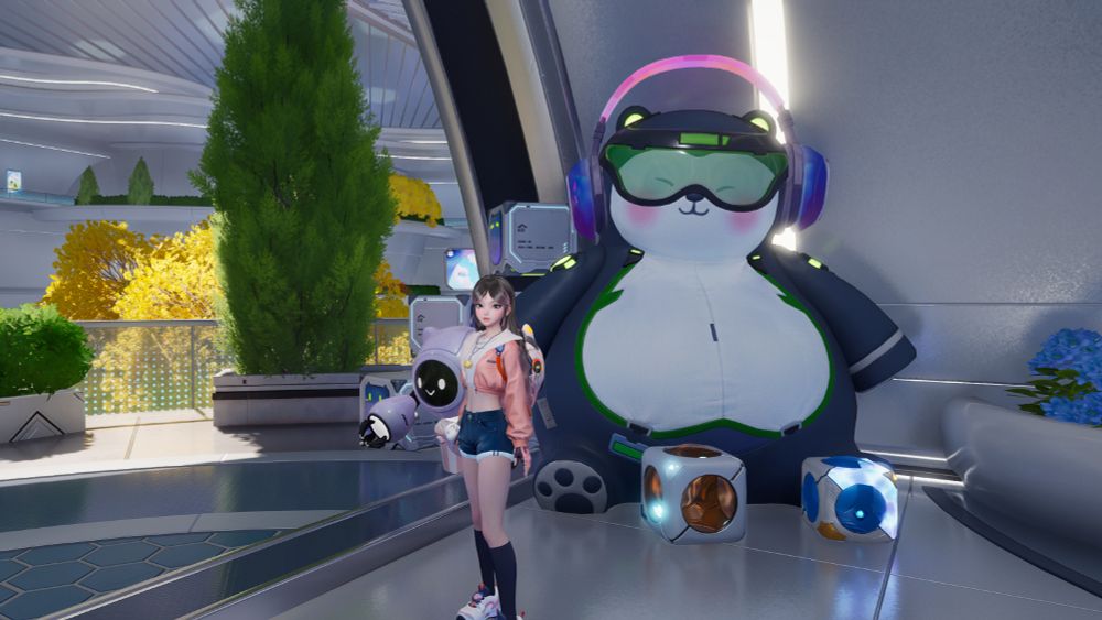 Screenshot from the closed beta of Aniimo. My character is in the starting area standing in front of a giant bear-like plushie that is wearing green tinted ski goggles, as well as pink and purple headphones. A robot and large replications of the aniimo pods are around the plushie.