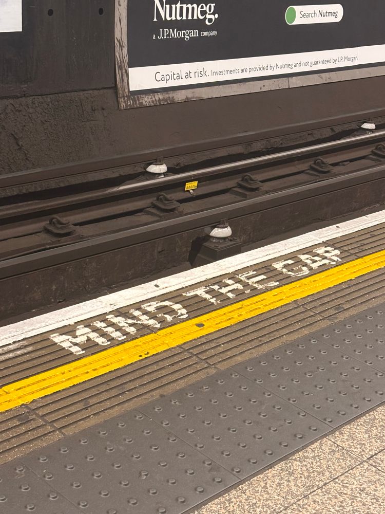 A British subway station reminder on the ground—says Mind The Gap.