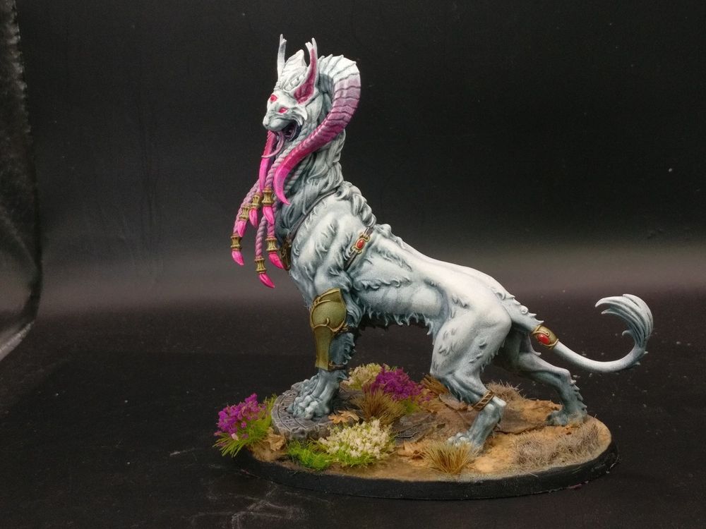 The Incubator, a Mindstealer Sphiranx model. White-furred, pink eyed big cat with gold jewelry and pink accents painted to suggest Madoka Magica's Kyubey. Side