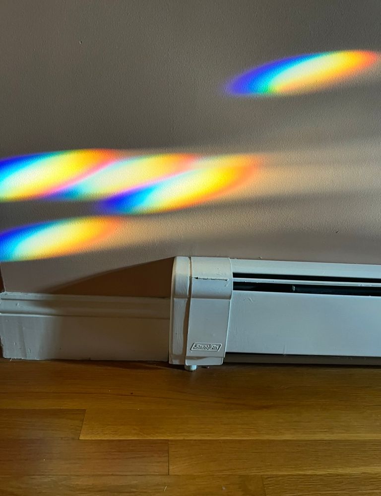 Morning prisms on my front hall wall.