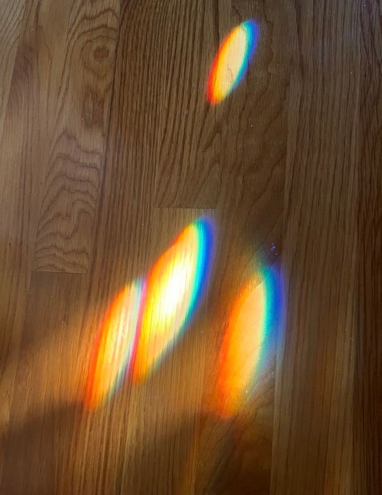 Morning prisms on my front hall floor.