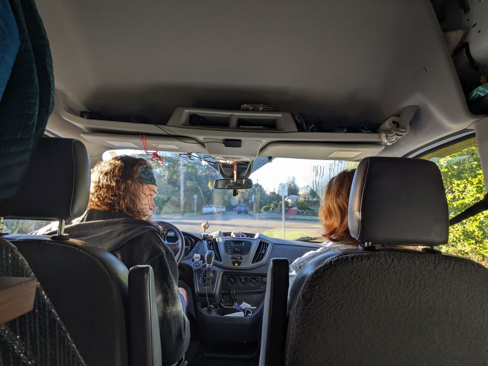 Two folks in the front seats of a van