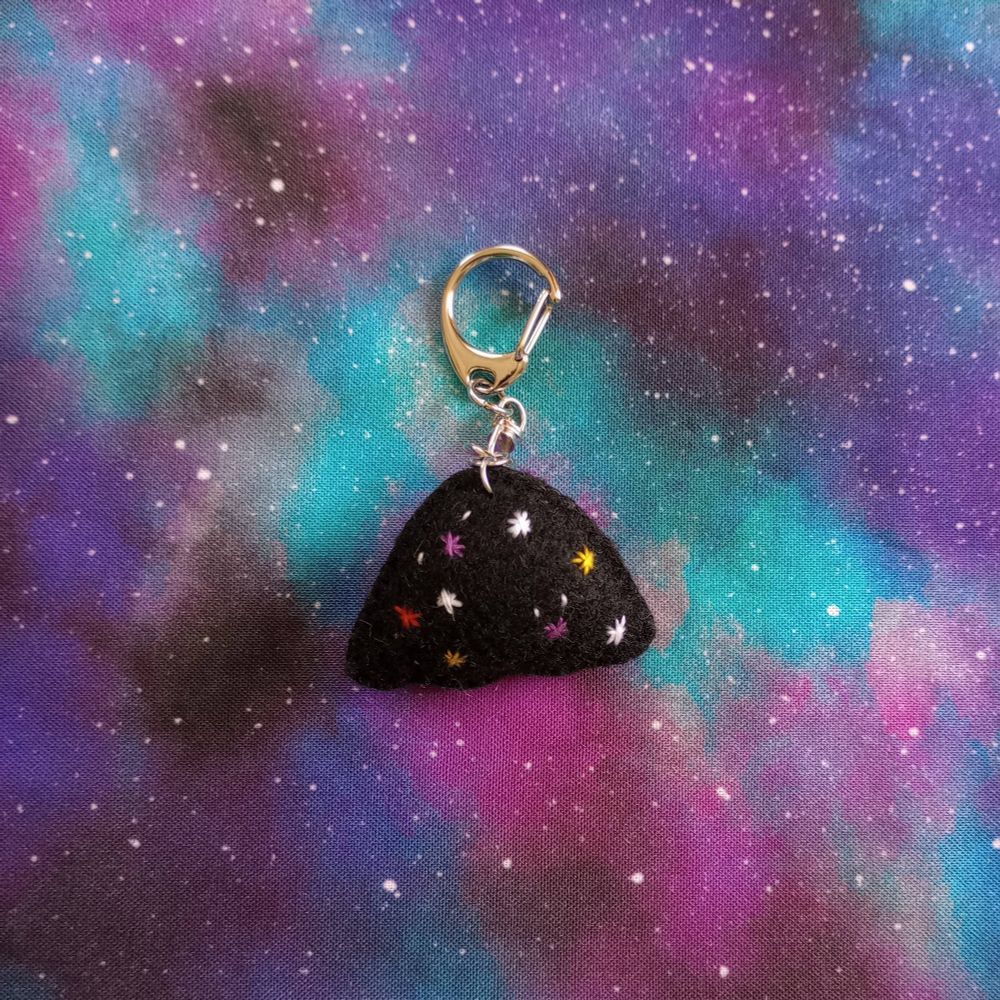 Here's a lovely peek at the back of the charm. Again, she's covered with embroidered white, yellow, red and purple stars.