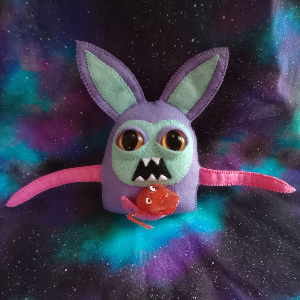 Here's another lovely photo of Theodore where he's holding a red monster finger puppet in his pouch.