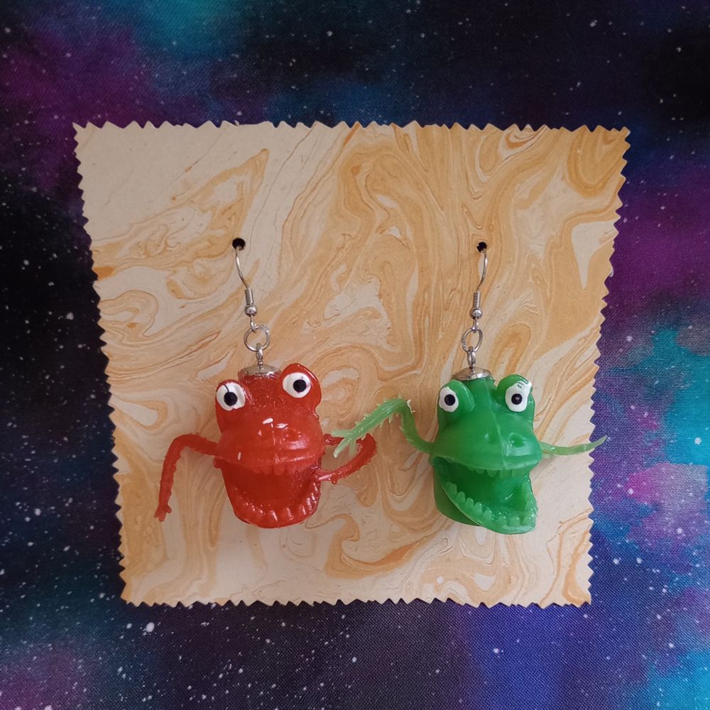 Here's another pair of earrings. This one has a vintage red monster finger puppet and a green one.