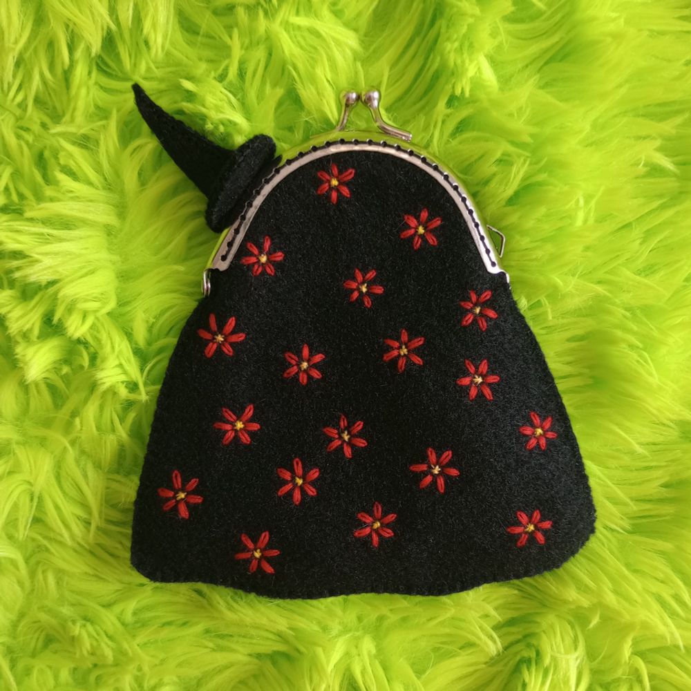 Here's another lovely pic of the ghost bag. This is a view of her back, which is covered with embroidered red flowers. She's wearing the witch hat here as well.