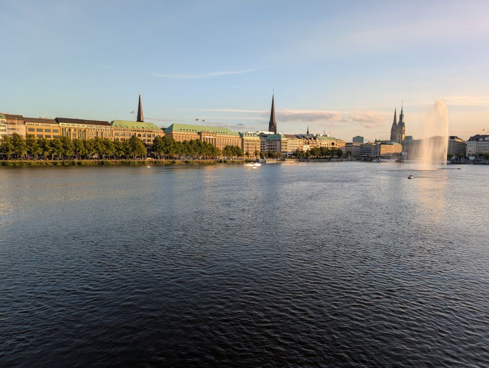 Picture of buildings across a manmade lake as the sunsets in Hamburg