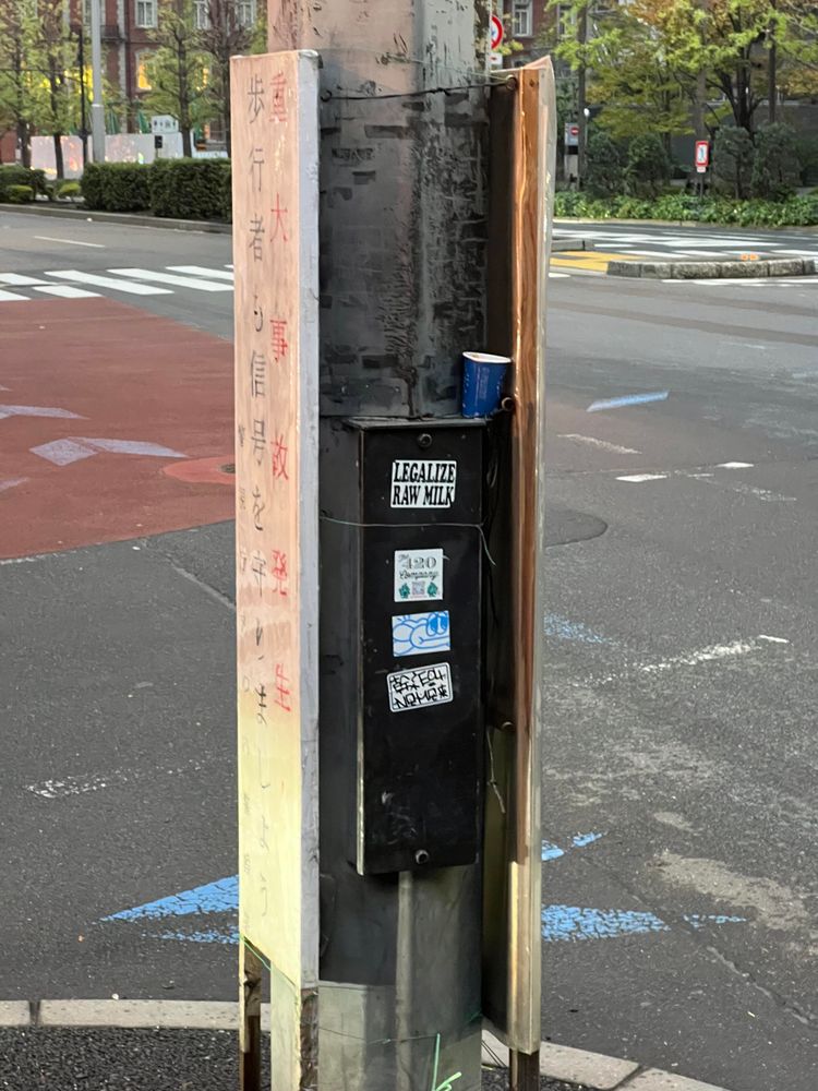 LEGALIZE RAW MILK sign on lamppost in Tokyo.