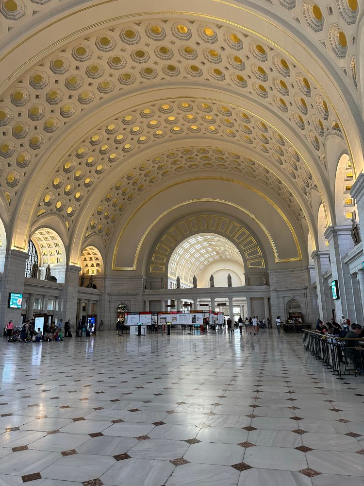 A photo of the primary train station in Washington, DC, with glossy tiles floor, arching ceiling and windows, and hardly any people.