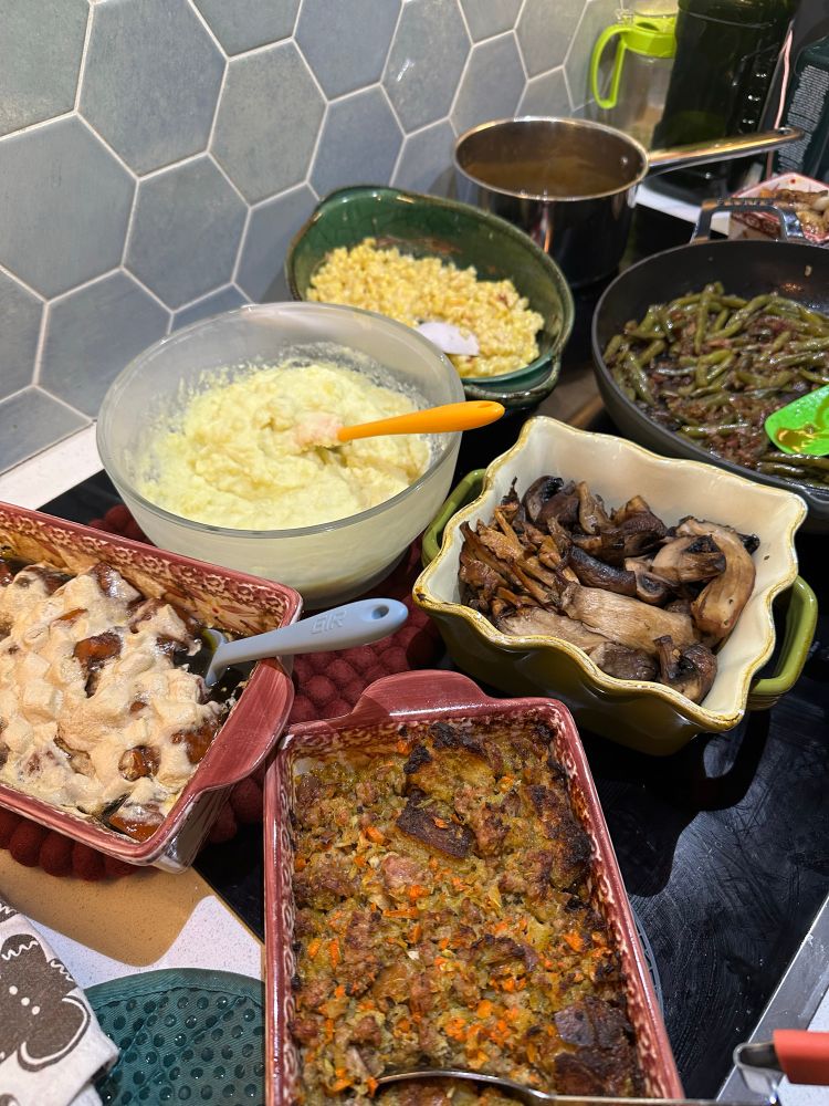 A collection of side dishes on a stovetop. 
