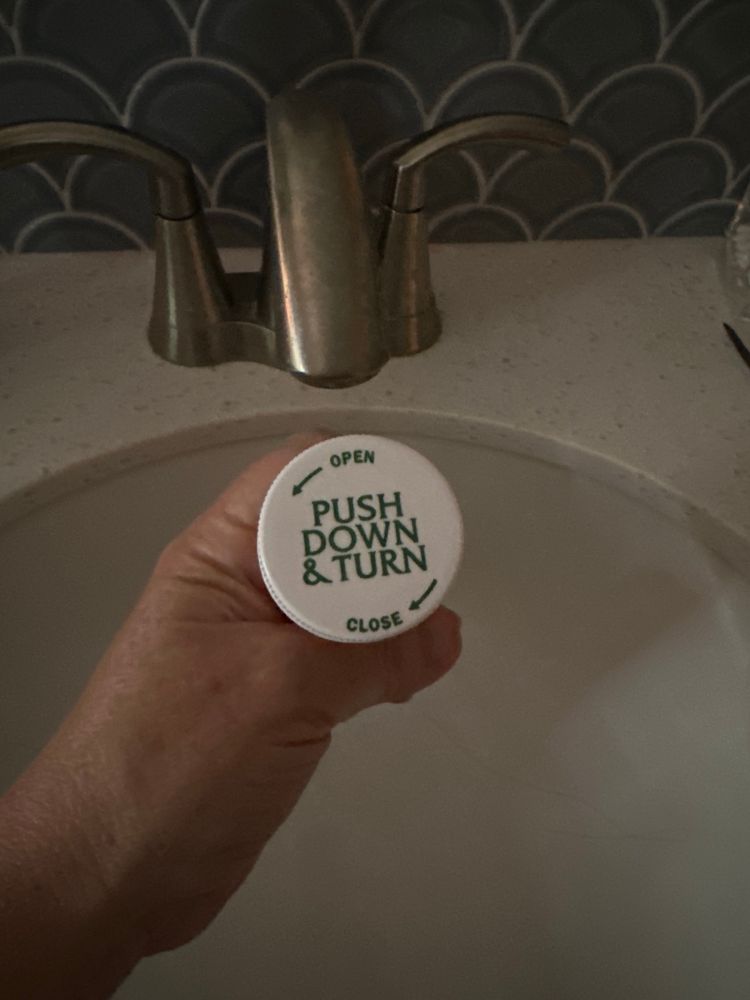 The top of a prescription bottle, which says “Push Down & Turn” in the “Law & Order” font. 