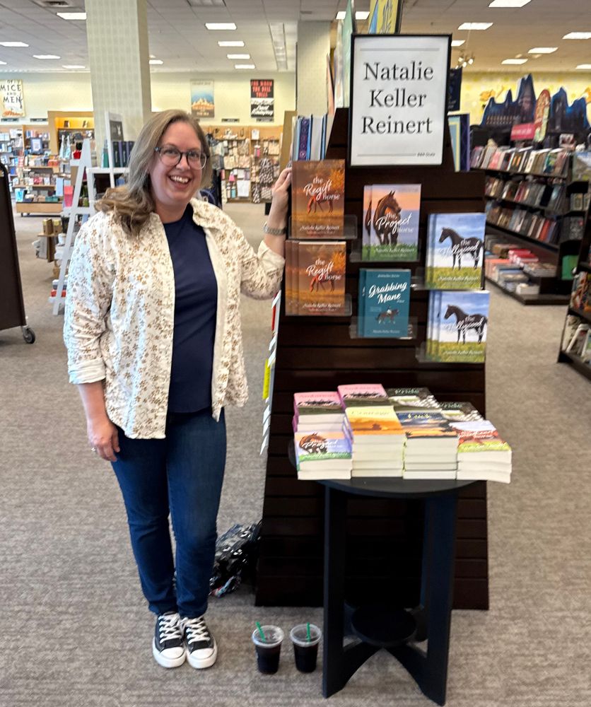 I’m standing next to an endcap with my books including Ocala Horse Girls, Grabbing Mane, and Eventing Series 