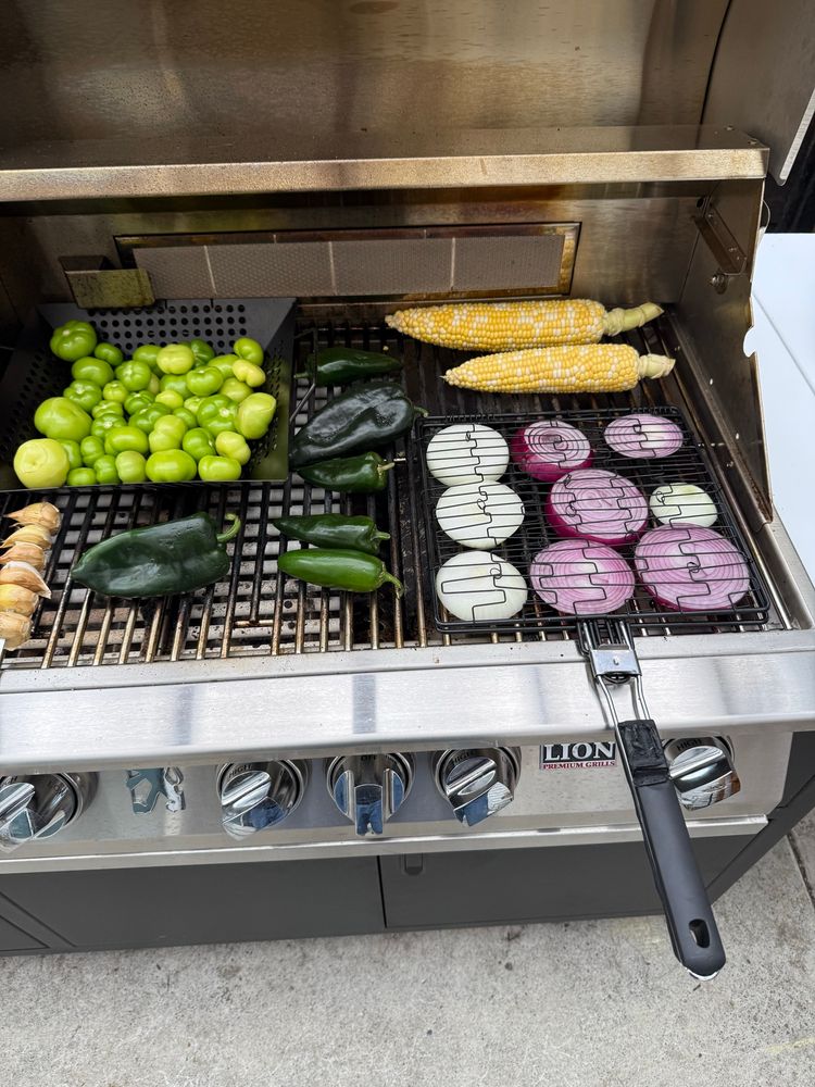 Veggies on the grill- basket of tomatillos, skewer of elephant garlic, corn on the cob, red and yellow onions, poblanos and a jalapeño. 
