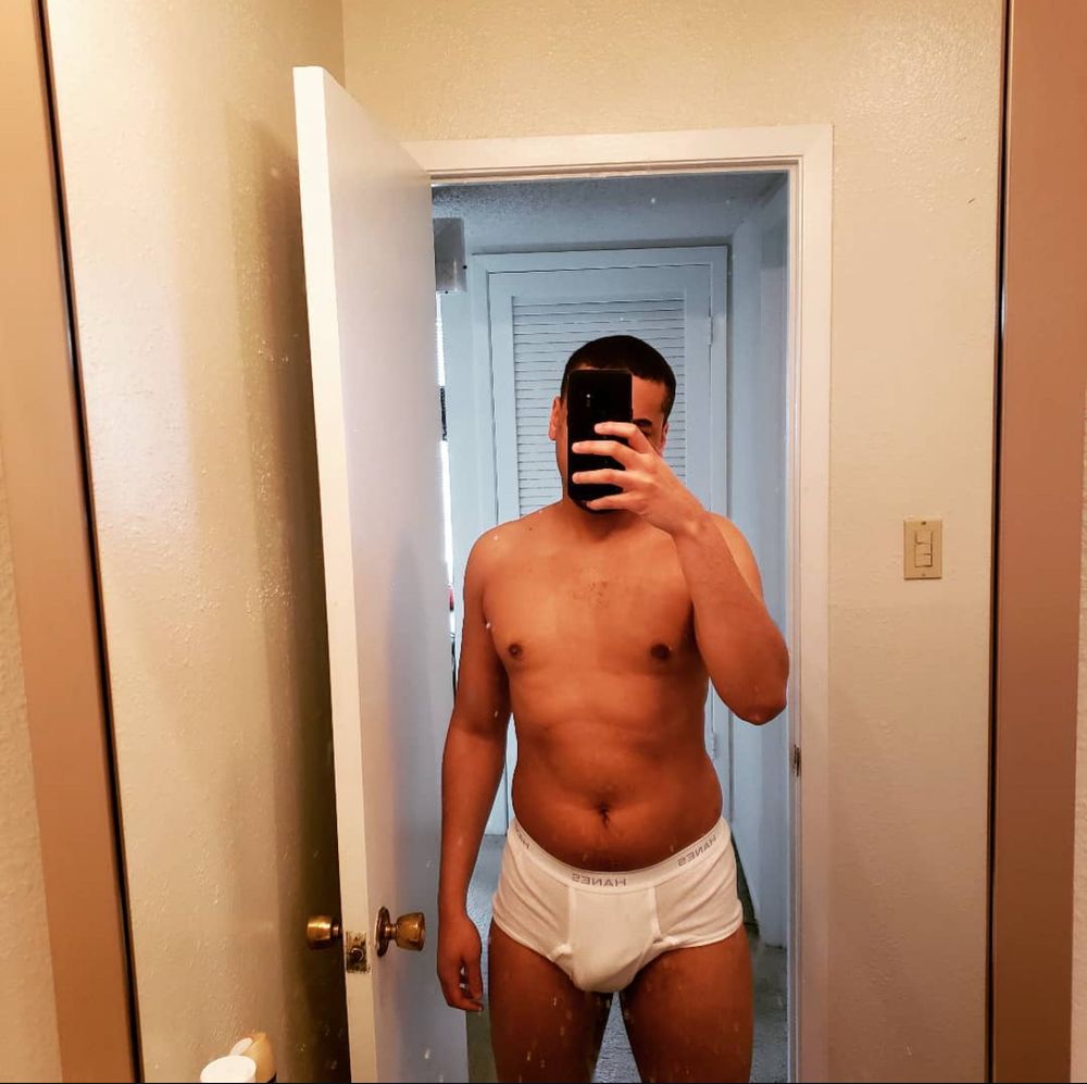 Me taking a mirror selfie in white Hanes briefs. This picture was almost 4 years ago and I had less muscle definition and more fat on my body.