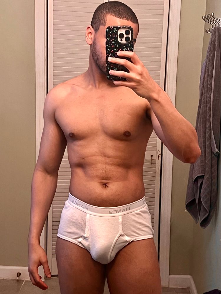 Me taking a mirror selfie wearing white Hanes briefs