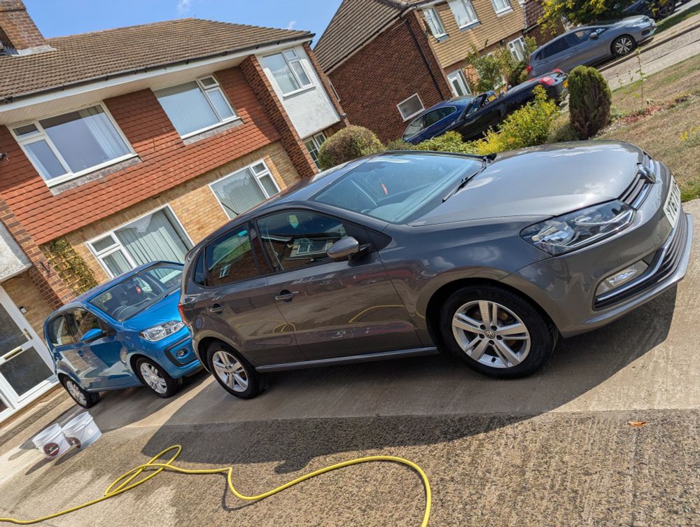 A picture of two Volkswagen cars, a Polo and Up, which have just been washed by hand