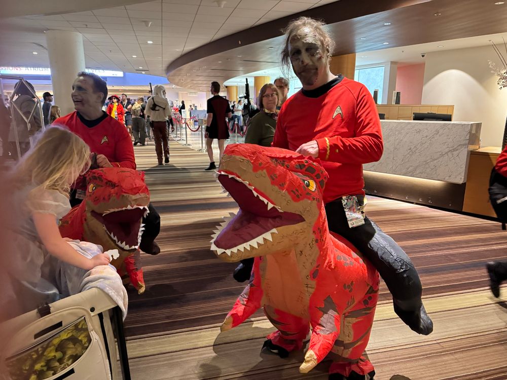 Zombie redshirts riding inflatable dinosaurs. I have no idea what this is. 