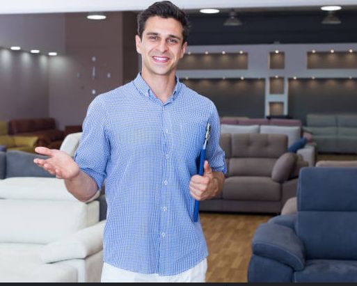 Photo of a furniture salesman approaching a cusomer.