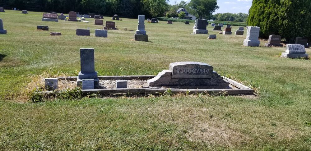 A few headstone surrounded by a wooden border You see family plots like this occasionally It have the vibe of being private without being private 