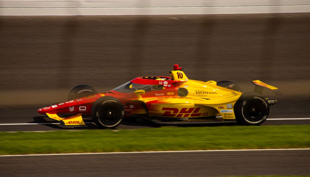 The red & yellow #10 DHL Honda IndyCar tests at Indianapolis Motor Speedway 