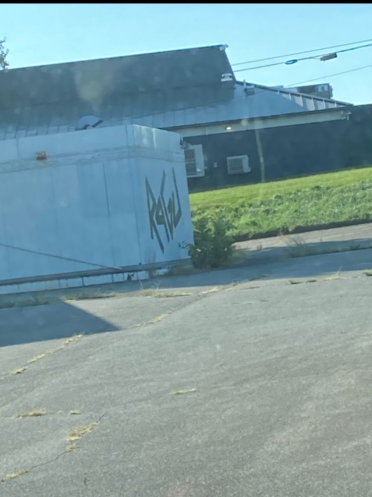 Graffiti on a trailer that says RAGU