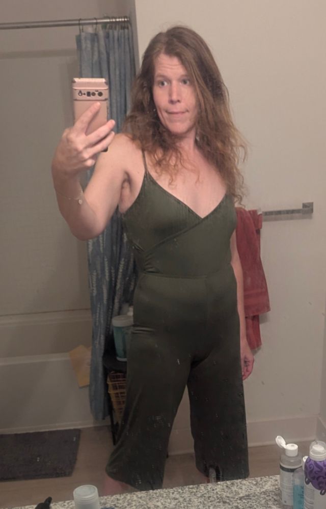 me wearing a green jumpsuit with spaghetti straps