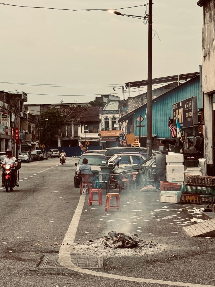 7th month burnt offering on the ground in front of the hawker centre