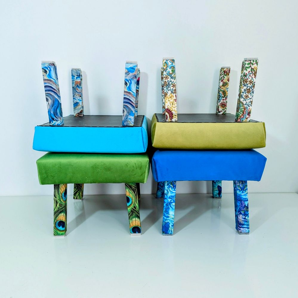 4 different foot stools with bright velvet covers and complimentary design fabric feet