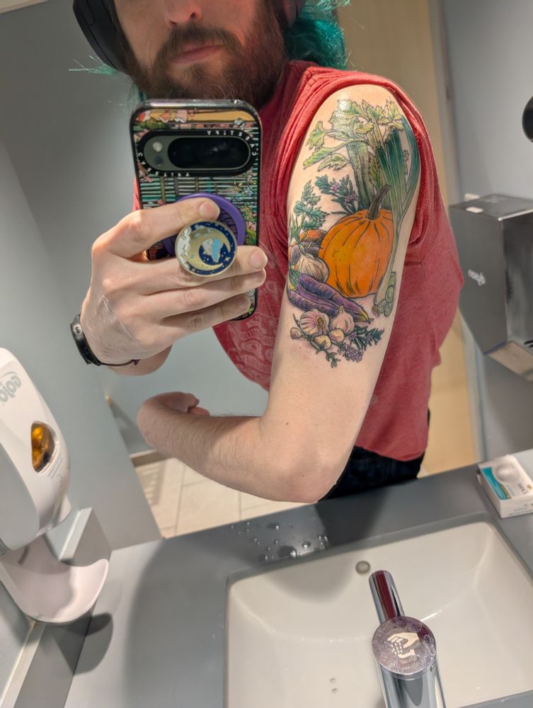 Showing off of an arm tattoo of vegetables 